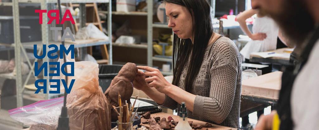 Student sculpting with clay