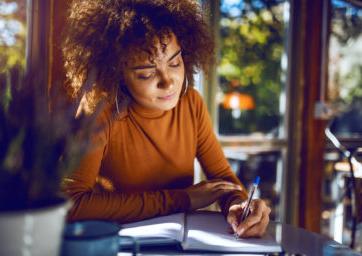 Woman writing on paper